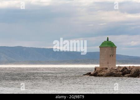 Croatia, Brac Island, Bol. Lighthouse marks entrance marina. Stock Photo