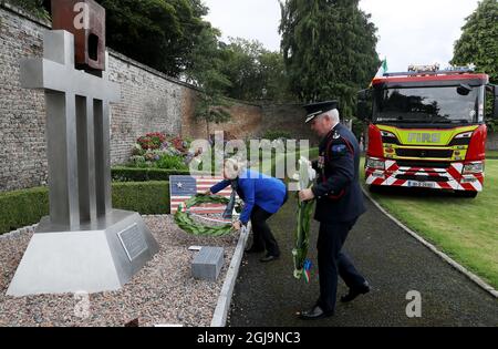 Charge d'Affaires Alexandra McNight (left) and Dennis Keeley, acting Chief Officer Dublin Fire Brigade, lay wreaths during a 20th anniversary event at the US Ambassador's Residence in Dublin to commemorate the lives lost during the 9/11 attacks. Picture date: Wednesday August 25, 2021. Stock Photo