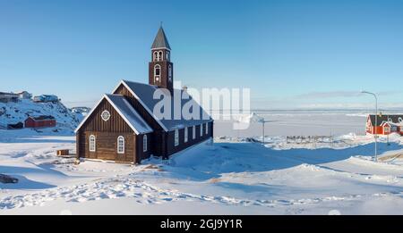 Zions Church, a landmark of Ilulissat. Winter in Ilulissat on the shore of Disko Bay. Greenland, Denmark. (Editorial Use Only) Stock Photo