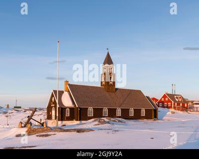 Zions Church, a landmark of Ilulissat. Winter in Ilulissat on the shore of Disko Bay. Greenland, Denmark. (Editorial Use Only) Stock Photo