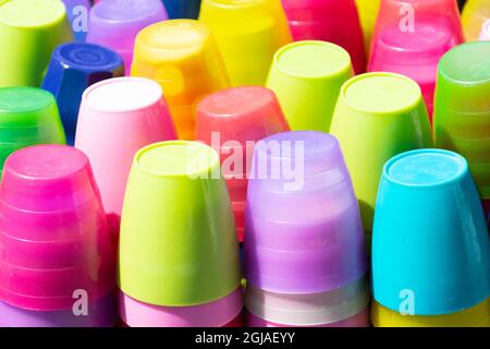Closeup shot of stacks of colorful plastic cups Stock Photo