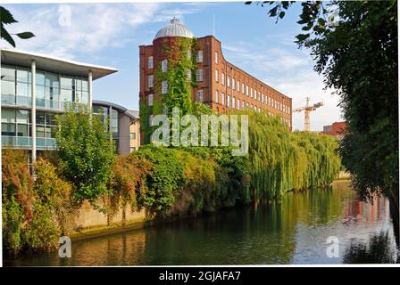 A view of the 19th century St James Mill by the River Wensum downstream of Whitefriars Bridge in the City of Norwich, Norfolk, United Kingdom. Stock Photo