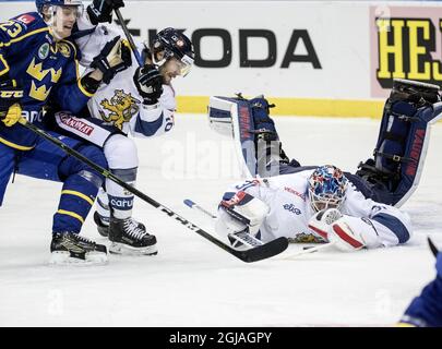 Countries playing corrected! GOTEBORG 2017-02-12 Finish goalkeeper Mikko Koskinentar reaches for the puck in front of Finlands Mikko Kousa (C) Sweden's Fredrik Handmark (L) during the Sweden Hockey Games match Sweden vs Finland at the Scandinavium Arena in Goteborg, Sweden, February 12, 2017. Photo: Bjorn Larsson Rosvall / TT / ** SWEDEN OUT ** Stock Photo