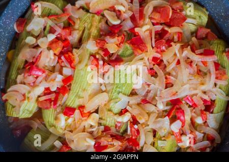 Zucchini with olive oil. It is cooked with finely chopped onions, peppers and garlic. Mediterranean cuisine. Stock Photo