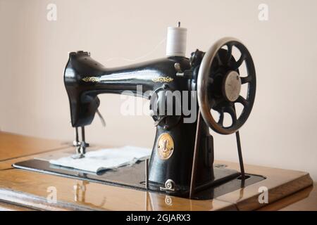 very old model, antique pedal sewing machine and table Stock Photo - Alamy