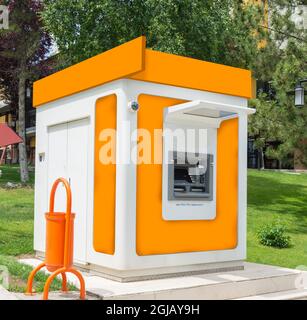 with one cash machine, ATM, dustbin and security camera in the park. Orange Stock Photo