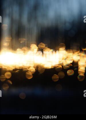 Abstract pattern de-focused points of golden light against the dark blue background Stock Photo