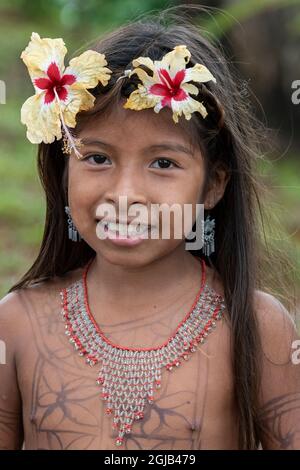 Central America, Panama, Gatun Lake. Embera Indian village. Young Embera girl with flowers in her hair. Stock Photo