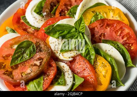 Healthy Homemade Heirloom Tomato Caprese Salad with Basil and Mozzarella Stock Photo