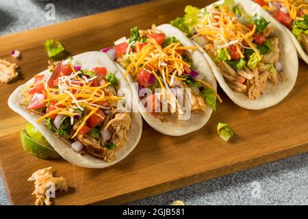 Homemade Shredded Chicken Tacos with Lettuce Cheese Tomatoes Stock Photo