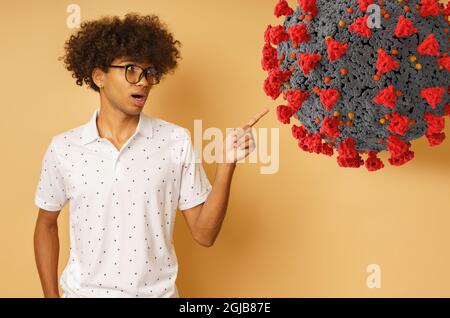 Amazed man with glasses indicates something with hand Stock Photo