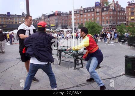 An Arsenal supporter (far left) clashes with two Galatasaray supporters in Copenhagen's Town Hall Square before the UEFA Cup final between the two clubs later the same day  Stock Photo