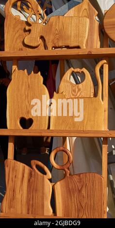 Handmade wooden cutting boards in the form of animal figures. Vertical  Stock Photo
