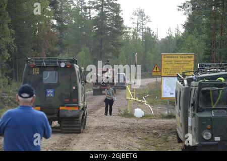 Tracked vehicles on the road which is the border to a shooting range which also works as a firebreak against the major wild fire at Alvdalens shooting range in Trangslet, Dalarna, Sweden July 21, 2018. Photo Nisse Schmidt / TT kod 40421  Stock Photo