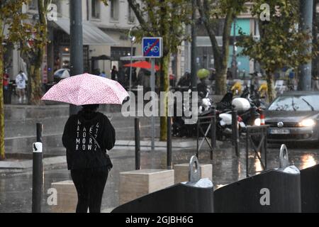 Marseille, France. 3rd Sep, 2021. A woman walks along the streets of Marseille while holding an umbrella during a rainy day. (Credit Image: © Gerard Bottino/SOPA Images via ZUMA Press Wire) Stock Photo