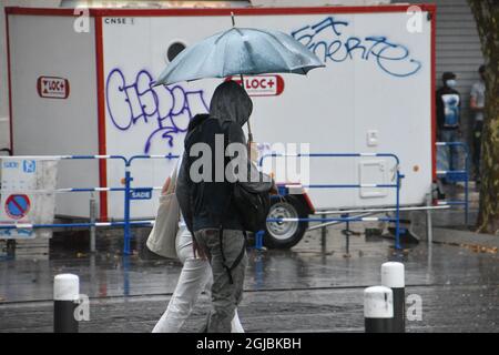 Marseille, France. 3rd Sep, 2021. A couple walk through the streets of Marseille holding an umbrella on a rainy day. (Credit Image: © Gerard Bottino/SOPA Images via ZUMA Press Wire) Stock Photo