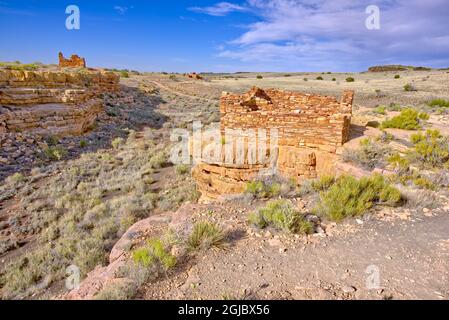 View of 2 Box Canyon Indian Dwellings with the Lomaki Pueblo in the far background. Located in the Wupatki National Monument near Flagstaff Arizona. Stock Photo