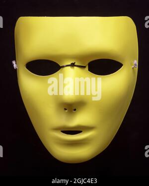 Blank Face Yellow Half Mask Isolated Against Black Background. Stock Photo