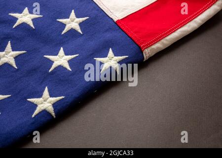 USA sign symbol. United States of America flag folded on black color background, Memorial day and 4th of July, Independence day concept. Copy space, t Stock Photo