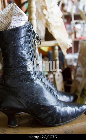 Woman's leather lace-up shoe antiques and old items in store in Leadville, Colorado. Stock Photo