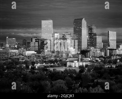 Denver, Colorado skyline glistens in early evening against the Rocky Mountains Stock Photo