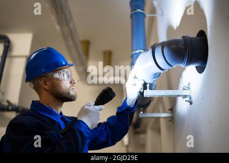 PVC Water Pipe Inspection By Construction Worker Stock Photo