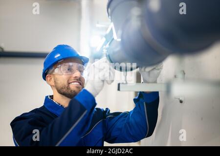 PVC Water Pipe Inspection By Construction Worker Stock Photo
