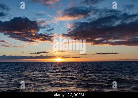 Sunset over the Pacific Ocean from tour boat in Kauai, Hawaii, USA Stock Photo
