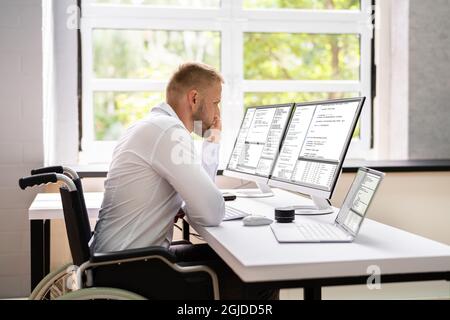 Computer Programmer Writing Program Code On Computer In Office Stock Photo