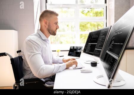 Computer Programmer Writing Program Code On Computer In Office Stock Photo