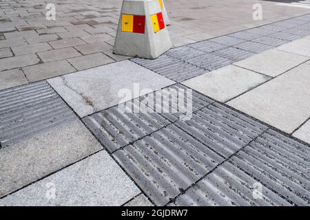 Tactile paving, tactile guideways for the visually impaired, blind people. Photo: Amir Nabizadeh / TT code 12040  Stock Photo