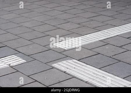 Tactile paving, tactile guideways for the visually impaired, blind people. Photo: Amir Nabizadeh / TT code 12040  Stock Photo