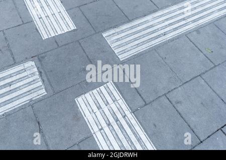 Tactile paving, tactile guideways for the visually impaired, blind people. Photo: Amir Nabizadeh / TT code 12040  Stock Photo