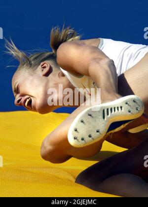 Swedish high jumper Kajsa Bergqvist clutches the back of her foot after her Achilles' tendon snapped. Bergqvist, who was a gold medal candidate for the Olympic Games will now miss the event.   Stock Photo