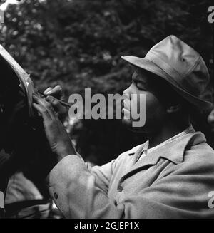 Joe Louis, American boxer signing autographs during a training camp in Pompton Lakes, New Jersey. Louis was world heavyweight champion in 1937, he retired as undefeated champion after having defended the title 25 times. Stock Photo