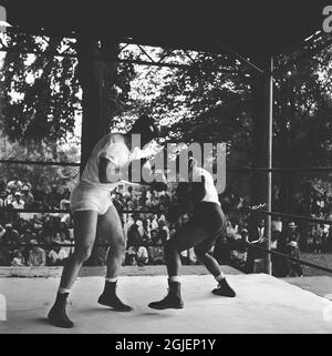 Joe Louis, American boxer spars during a training camp in Pompton Lakes, New Jersey. Louis was world heavyweight champion in 1937, he retired as undefeated champion after having defended the title 25 times. Stock Photo