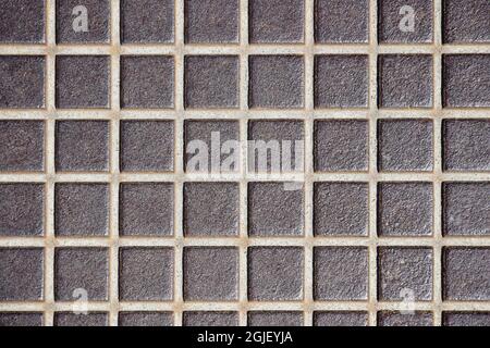 Embossed old metal floor texture, surface  in a cage . Rusty metal floor, industrial flooring. Close-up. Selective focus. Copy space. Stock Photo