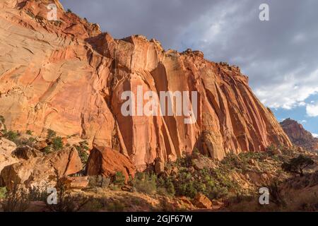 USA, Utah, Capitol Reef National Park, Storm clouds gather over steep cliffs of Wingate Sandstone near opening of Capitol Gorge. Stock Photo