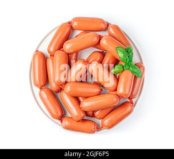 Raw sausages and basil isolated on a white background. Stock Photo