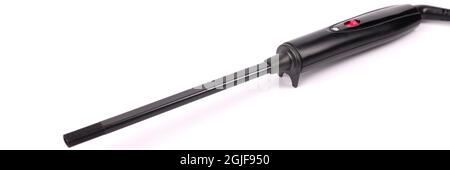 Black hair curling iron lying on white background closeup Stock Photo