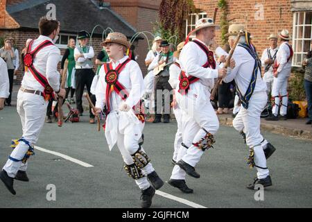 The Stafford Morris and Uttoxeter Heart of Oak Morris Teams dance together during the Abbots bromley Horn festival on the first Monday in September. Stock Photo