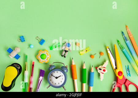 Different school supplie on the green background.Back to school concept,top view. Stock Photo