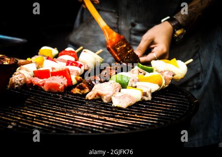 Summer or spring barbecue outdoors Close up Mouth Watering Gourmet Barbecue on Wooden Chopping Board at the Table. Stock Photo