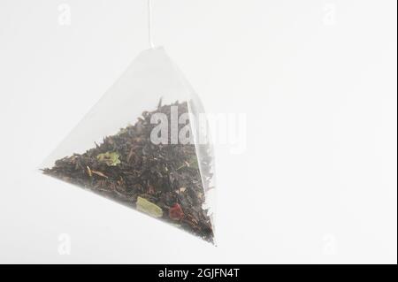 Teabag triangle shape isolated on white studio background  close up view Stock Photo