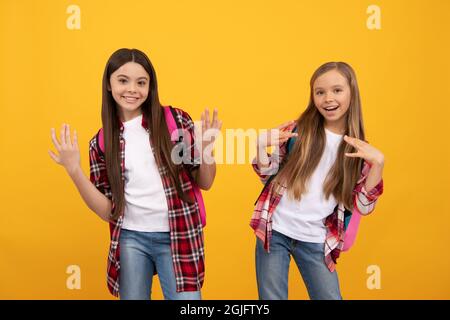 happy cool kids in casual checkered shirt carry backpack, high school Stock Photo