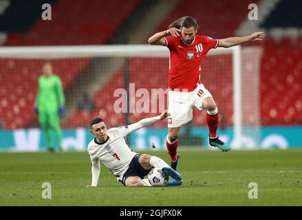 Grzegorz Krychowiak of Poland battles with Phil Foden of England during England v Poland football match Stock Photo