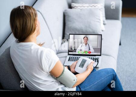 Patient Testing Blood Pressure In Telehealth Telemedicine Call Stock Photo