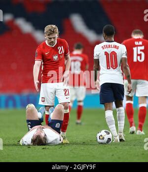 Kamil Jozwiak of Poland and Harry Kane  of England during England v Poland football match Stock Photo