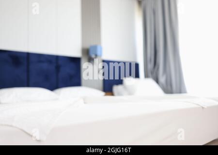 Modern hotel bedroom with two beds blurred background Stock Photo