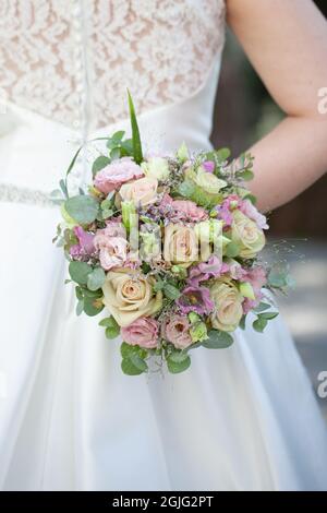 beautiful wedding bouquet in the hands of the bride. High quality photo Stock Photo